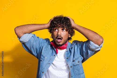 Photo portrait of nice young male look shocked empty space dressed stylish denim outfit red scarf isolated on yellow color background