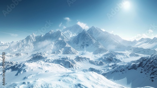 A mountain range covered in snow with a clear blue sky in the background. The sky is filled with clouds, giving the scene a serene and peaceful atmosphere