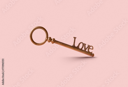 Vintage bronze key with word Love on clipping path in studio photo