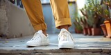 Closeup of stylish sneakers paired with joggers and a tailored blazer showcasing the versatility of athleisure from fitness to fashion. Concept Fashion, Athleisure, Sneakers, Stylish Outfit