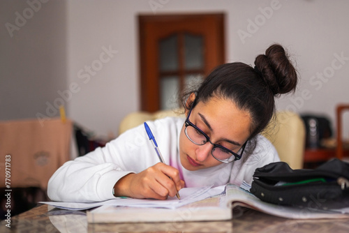 teenager studying at home photo