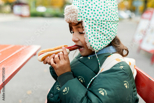 kid eating hotdog photo