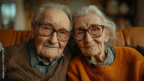 An elderly couple with glasses sitting on a couch. Generative AI.