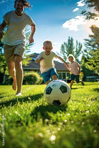 Family playing soccer in a sunny backyard