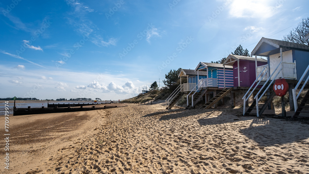 Obraz premium Wells beach and beach huts on the North Norfolk coast on a sunny day