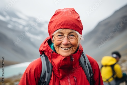 Active senior woman, 65 plus, enjoying hiking adventure in the breathtaking mountains