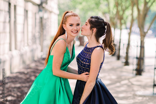 portrait of a friends in prom dresses