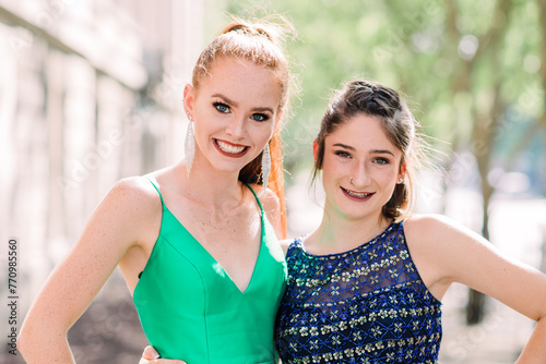 two high school friends in prom dresses