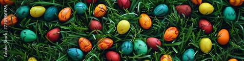 colored easter eggs on green grass background.