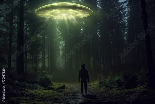 A lone person stands facing a hovering UFO amidst a dimly lit, mist-covered forest, suggesting a close encounter of the unknown kind photo
