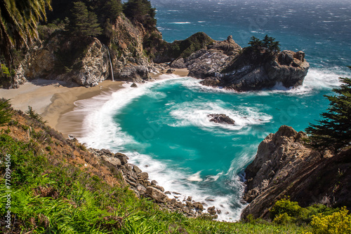 View of Waterfall and waves breaking in California on Highway 1 photo