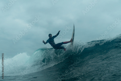 Professional surfer skillfully slide over the surface of choppy waters photo