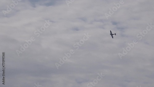 Vintage military airplanes spitfire hawker hurricane in Battle of Britain reenactment flying low in display.
