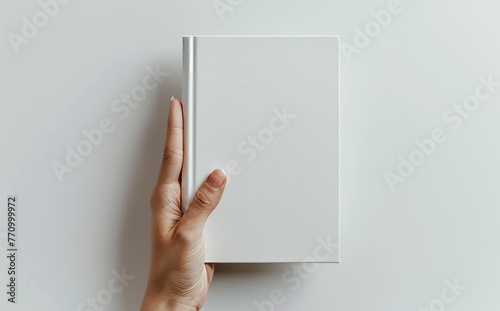 Woman's Hand Holding a White Magazine on a White Background Generative AI photo