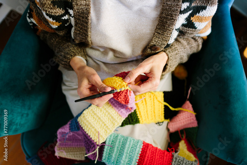 Top view of woman’s hands crocheting