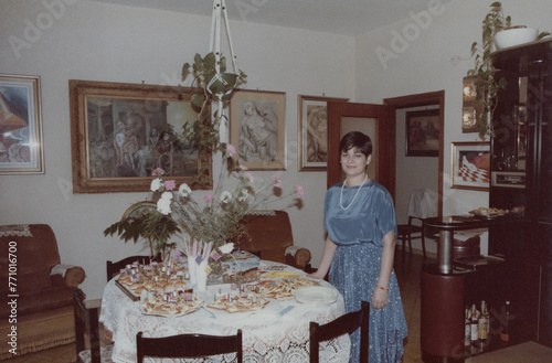 1986. Mother poses for a photo in the living room at home. photo