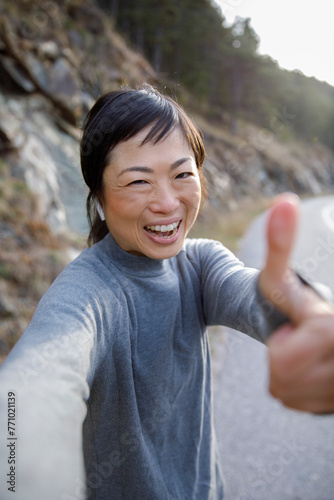 Cheerful athlete celebrating goal achievement with thumbs up