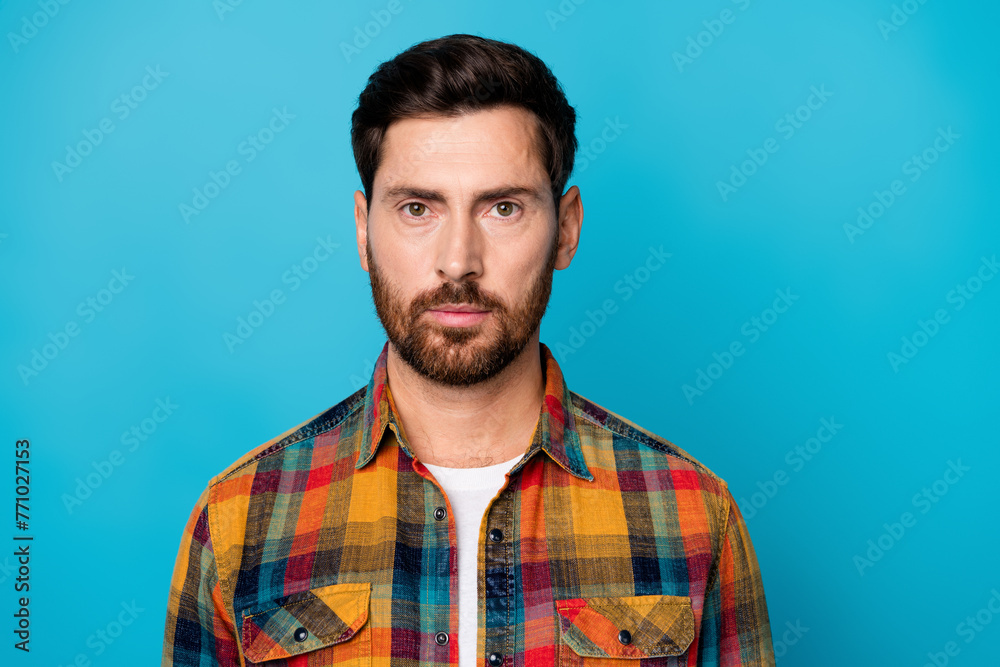 Fototapeta premium Portrait of serious confident professional worker with stubble wear checkered shirt staring at you isolated on blue color background