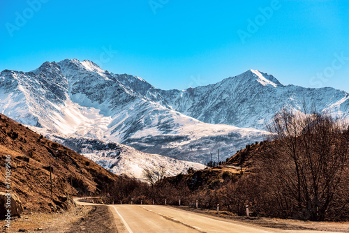 Landscape with a road passing at the foot of the snow-capped mountains in Alanya