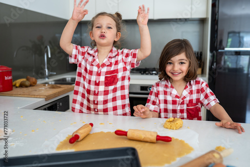 Sibling making Christmas cookies photo