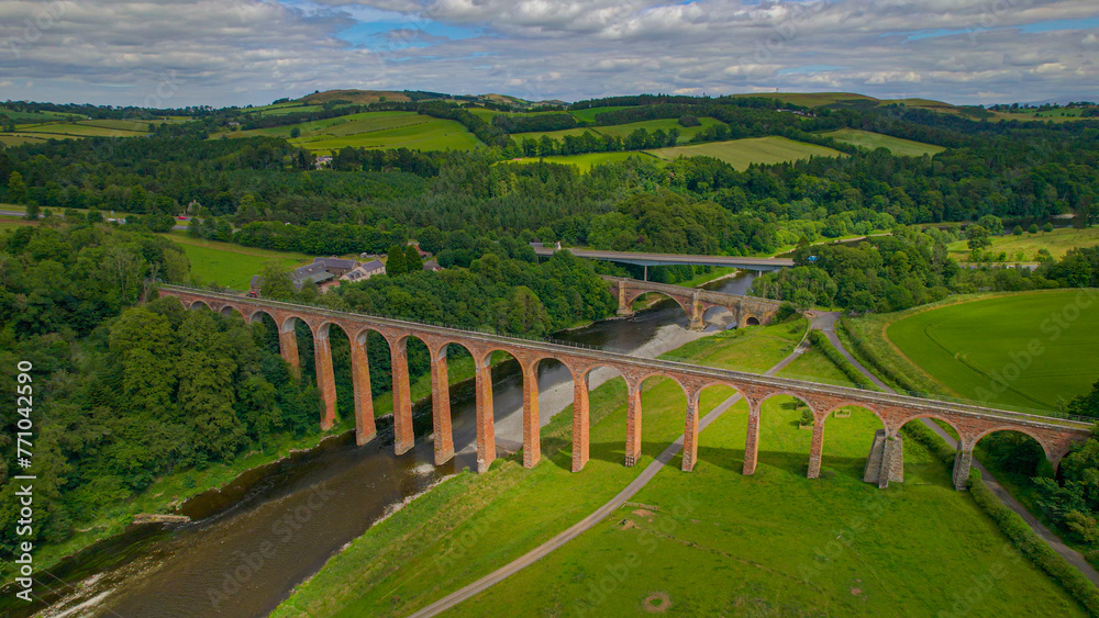 AERIAL: Magnificent Leaderfoot Viaduct embedded in picturesque green landscape