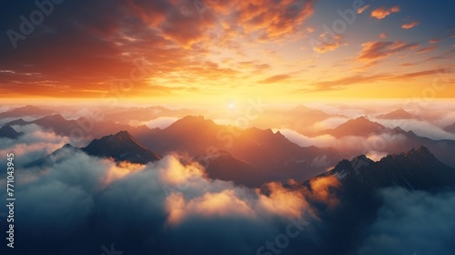 Beautiful golden sunset above cloud with sun shinning on horizon and mountain. © Alpa