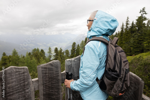 Mature hiker woman on top of a mountain photo