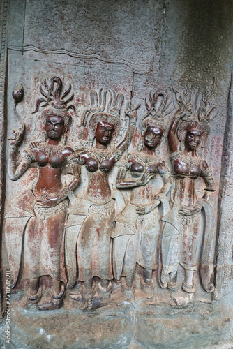 Apsara - Stone bas relief depicting Heavenly nymphs and celestial dancers at the courts of the Gods, carved in stone at Angkor Wat at Siem Reap, Cambodia, Asia photo