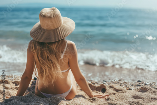 Summer vacation and travel concept. Woman with hat sitting on the beach. © Koray
