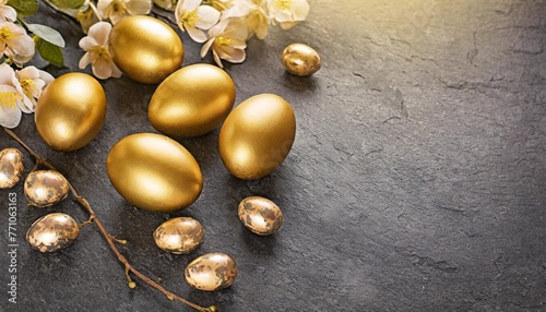 easter decoration golden eggs on dark shale background