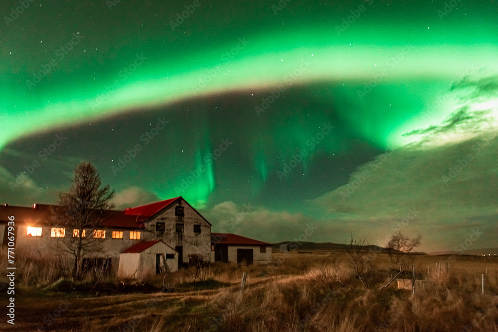 Northern Light,  spectacular Aurora borealis over a farm in Iceland
