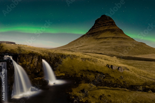 Beautiful scenery of Northern lights ( Aurora Borealis) on night starry sky over Kirkjufell mountain , Kirkjufellfoss waterfall in Iceland
