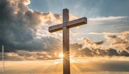 a handmade wooden cross over sky with clouds and sun