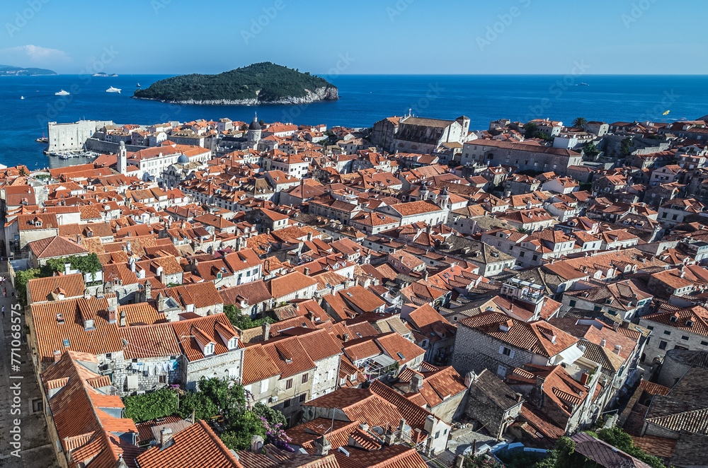 Aerial view from walls in Old Town of Dubrovnik city, Lokrum island on background, Croatia