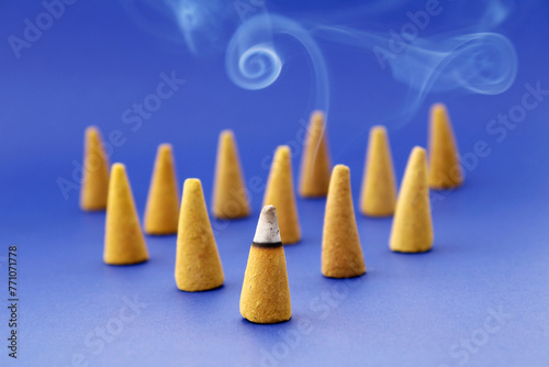 Cone shaped incenses with one of them burning in front