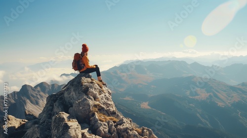 Adventurous Hiker Contemplating from Mountain Summit at Sunrise