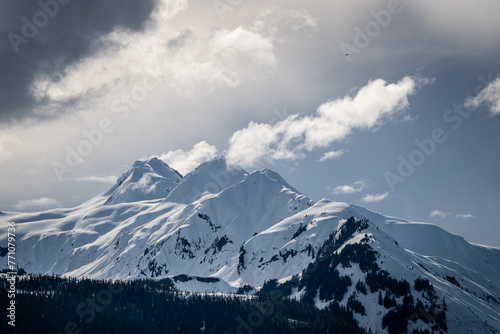 Dramatic snowy peaks emerging from storm clouds © JeremyWoodPhoto