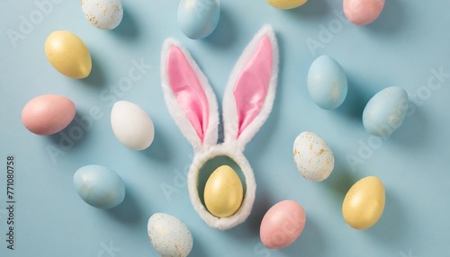 easter party concept top view photo of easter bunny ears white pink blue and yellow eggs on isolated pastel blue background with copyspace in the middle