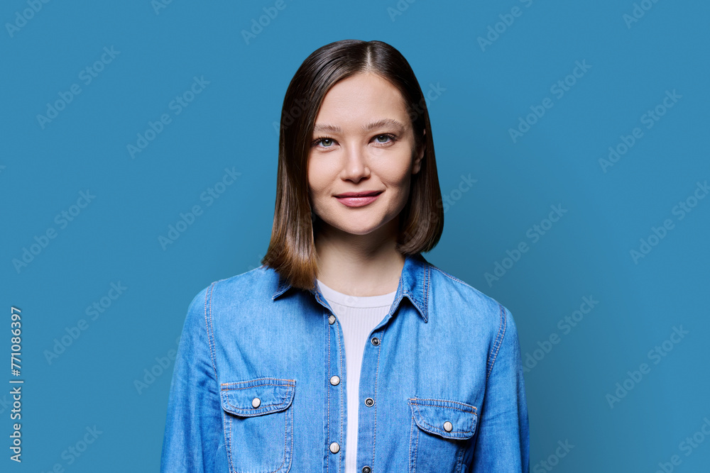 Young smiling attractive woman on blue background Young smiling attractive woman on blue background