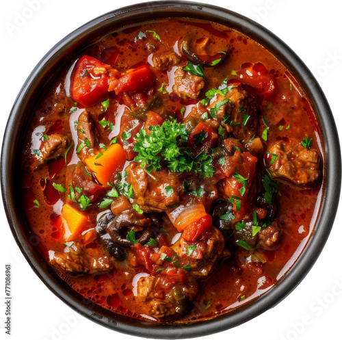 Savory beef goulash with vegetables in a dark bowl cut out on transparent background