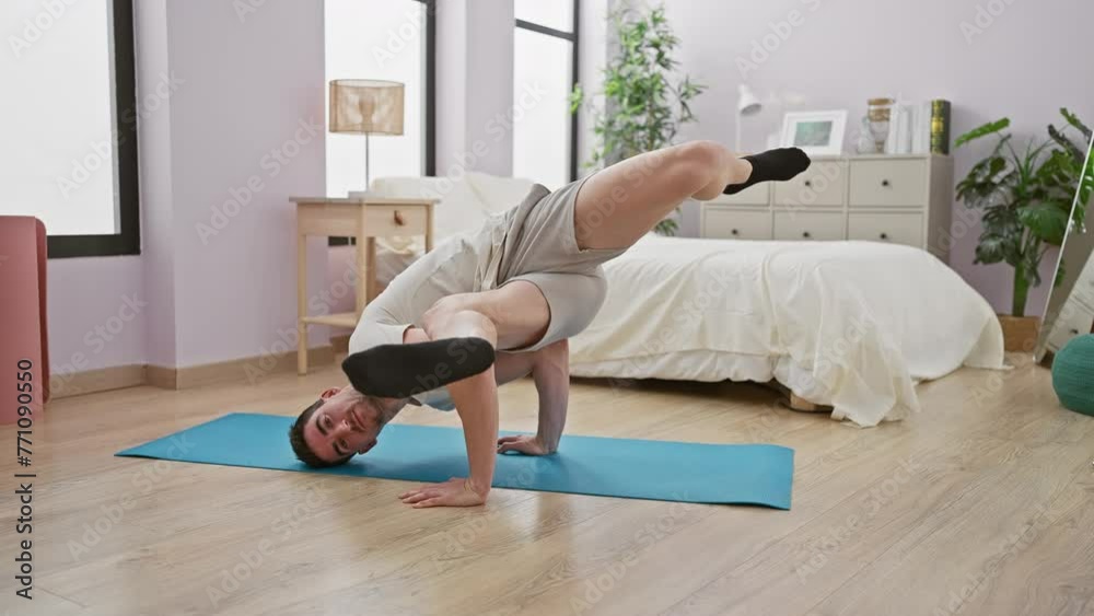 Young man practicing handstand in a modern bedroom, showcasing health and balance Young man practicing handstand in a modern bedroom, showcasing health and balance