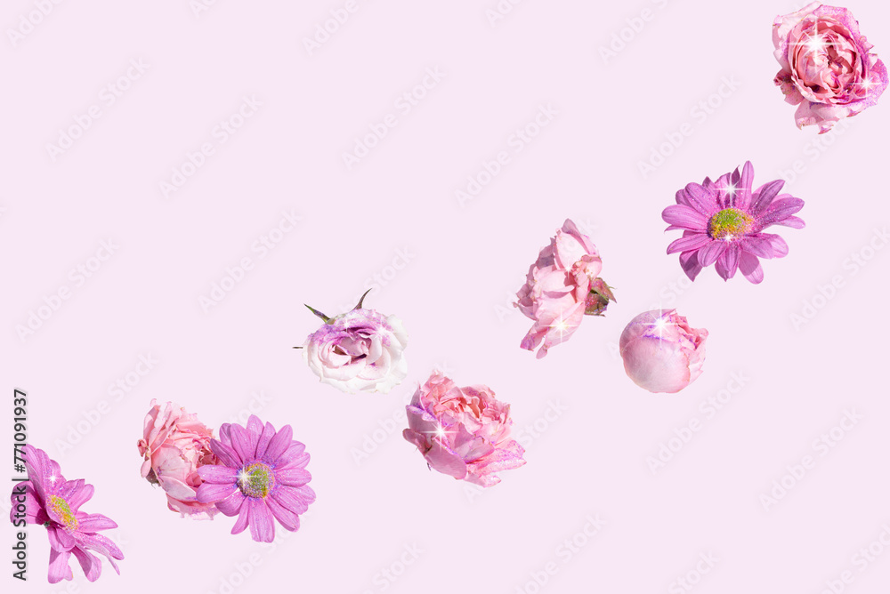 Beautiful spring flowers on a pink  background adorned with sequins and sparkle. Romantic aesthetic natural Summer concept.