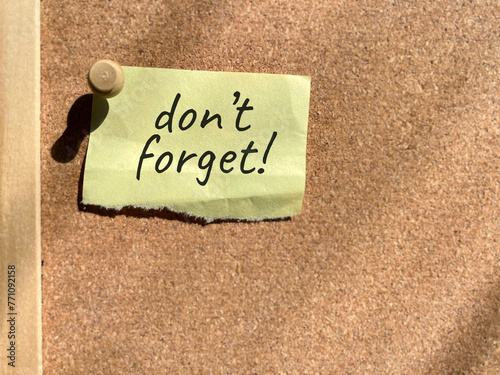 Notice reminder don't forget on bulletin board background. Stock photo.