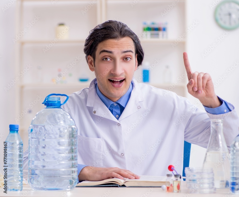 Young male chemist experimenting in lab Young male chemist experimenting in lab