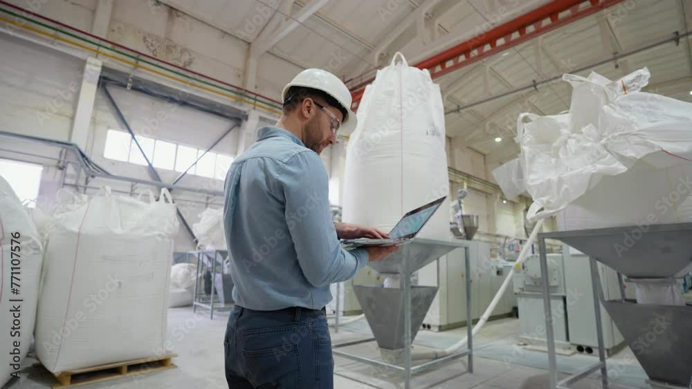 Farmer examining the loading of flour into large bags Farmer examining the loading of flour into large bags