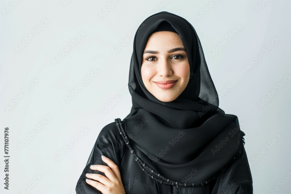 A woman wearing a black scarf and a black dress is smiling A woman wearing a black scarf and a black dress is smiling