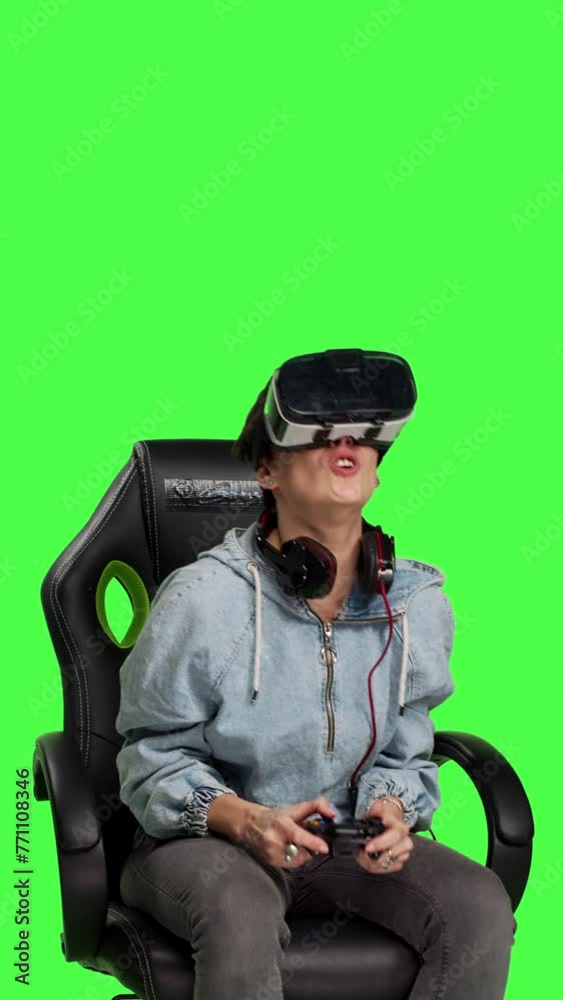 Front view Gamer losing at video games with virtual reality headset and controller, connecting online with her friends to play multiplayer championship. Woman gaming against greenscreen backdrop Front view Gamer losing at video games with virtual reality headset and controller, connecting online with her friends to play multiplayer championship. Woman gaming against greenscreen backdrop