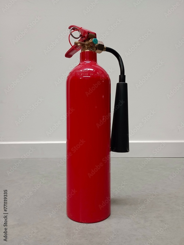 Obraz premium fire extinguisher in the work environment | bright background