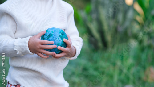 Adult person holding world globe, a healthy ecology to a new generation. Healthy ecology of the planet Earth. A healthy future for our generation. green glass background. Save the world.