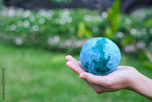 Adult person holding world globe  a healthy ecology to a new generation. Healthy ecology of the planet Earth. A healthy future for our generation. green glass background. Save the world.